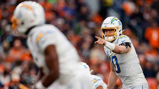 Jan 8, 2023; Denver, Colorado, USA; Los Angeles Chargers quarterback Justin Herbert (10) gestures at the line of scrimmage in the third quarter against the Denver Broncos at Empower Field at Mile High. Mandatory Credit: Isaiah J. Downing-USA TODAY Sports