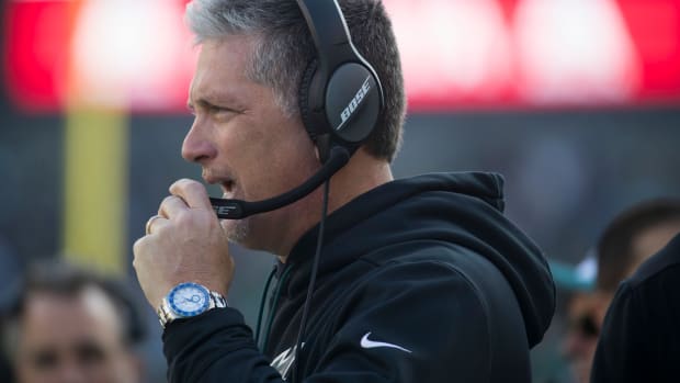 Eagles defensive coordinator Jim Schwartz speaks with the coaching staff Sunday at Lincoln Financial Field.