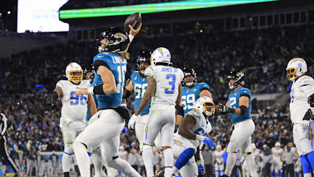 Jacksonville Jaguars quarterback Trevor Lawrence (16) spikes the ball after scoring a two point conversion during the fourth quarter of an NFL first round playoff football matchup Saturday, Jan. 14, 2023 at TIAA Bank Field in Jacksonville, Fla. Jacksonville Jaguars edged the Los Angeles Chargers on a field goal 31-30. [Corey Perrine/Florida Times-Union]