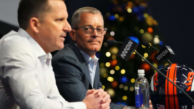 Denver Broncos CEO Greg Penner listens as general manager George Payton speaks at the UCHealth Training Center.