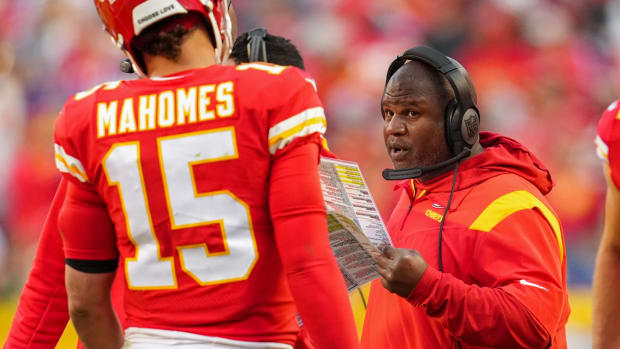Kansas City Chiefs offensive coordinator Eric Bieniemy talks with quarterback Patrick Mahomes (15) during the second half against the Buffalo Bills at GEHA Field at Arrowhead Stadium.