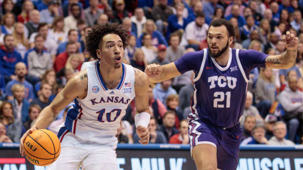 Jan 21, 2023; Lawrence, Kansas, USA; Kansas Jayhawks forward Jalen Wilson (10) drives around TCU Horned Frogs forward JaKobe Coles (21) during the second half at Allen Fieldhouse. Mandatory Credit: William Purnell-USA TODAY Sports