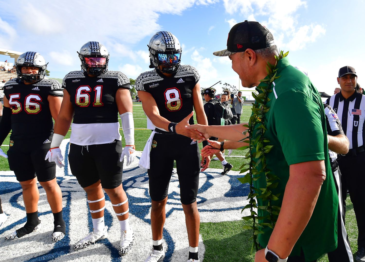 NFL retiree Jesse Sapolu shock hands with Team Mauka quarterback from Warren high school Nicholaus Iamaleava (8) prior to the coin toss of the Polynesian Bowl at Kunuiakea Stadium.