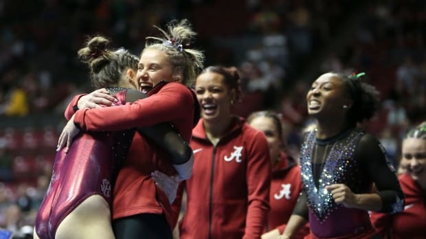 Alabama gymnast Gabby Gladieux gets a hug from teammates after dismounting from the balance beam during the meet with Florida Friday in Coleman Coliseum.