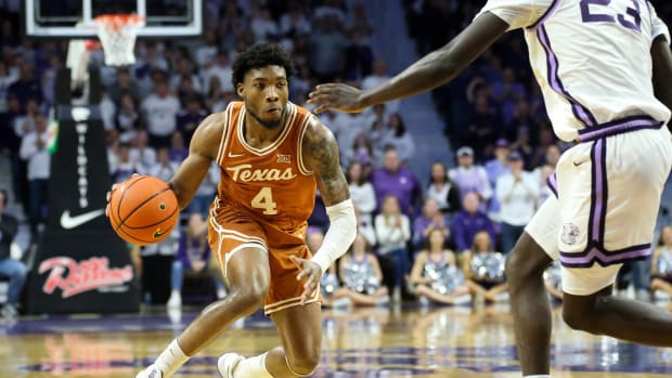 Feb 4, 2023; Manhattan, Kansas, USA; Texas Longhorns guard Tyrese Hunter (4) controls the ball against Kansas State Wildcats center Abayomi Iyiola (23) during the second half at Bramlage Coliseum.