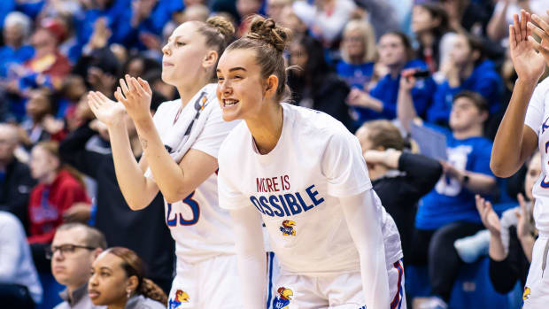 The Kansas Jayhawks bench cheers on their team in a game against the Texas Longhorns.