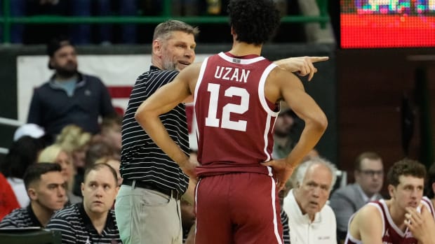Feb 8, 2023; Waco, Texas, USA; Oklahoma Sooners head coach Porter Moser talks with guard Milos Uzan (12) during a break in play against the Baylor Bears during the second half at Ferrell Center.
