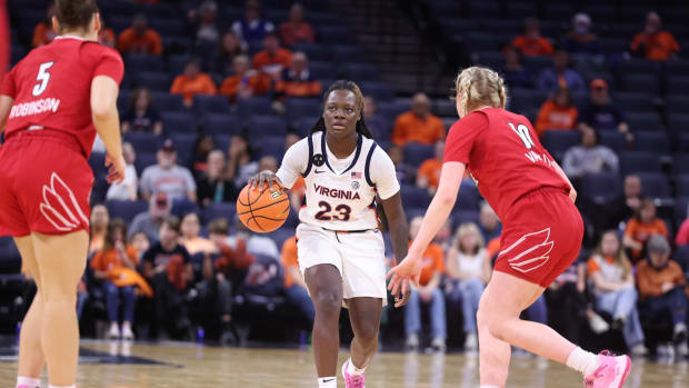 Alexia Smith dribbles the ball during the Virginia women's basketball game against Louisville at John Paul Jones Arena.