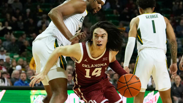 Feb 8, 2023; Waco, Texas, USA; Oklahoma Sooners guard Bijan Cortes (14) controls the ball against Baylor Bears forward Flo Thamba (0) during the first half at Ferrell Center. Mandatory Credit: Chris Jones-USA TODAY Sports