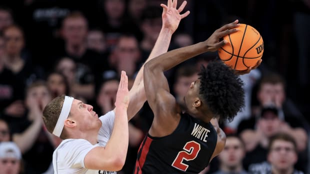 Feb 22, 2023; Cincinnati, Ohio, USA; Temple Owls guard Jahlil White (2) drives to the basket against Cincinnati Bearcats forward Viktor Lakhin (30) in the first half at Fifth Third Arena. Mandatory Credit: Aaron Doster-USA TODAY Sports