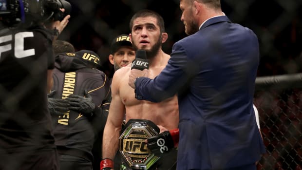 Islam Makhachev (red gloves) celebrates after defeating Alexander Volkanovski (not pictured) for the lightweight championship during UFC 284 at RAC Arena.
