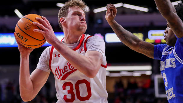 Jan 22, 2023; Cincinnati, Ohio, USA; Cincinnati Bearcats forward Viktor Lakhin (30) drives to the basket against Memphis Tigers guard Kendric Davis (3) in the first half at Fifth Third Arena. Mandatory Credit: Katie Stratman-USA TODAY Sports