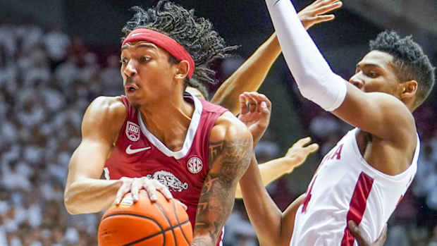 Arkansas Razorbacks guard Nick Smith Jr. against Alabama Crimson Tide's Brandon Miller.