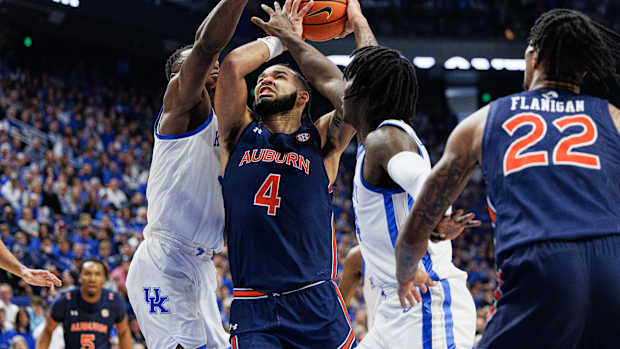 Feb 25, 2023; Lexington, Kentucky, USA; Auburn Tigers forward Johni Broome (4) goes to the basket against Kentucky Wildcats defenders during the first half at Rupp Arena at Central Bank Center. Mandatory Credit: Jordan Prather-USA TODAY Sports