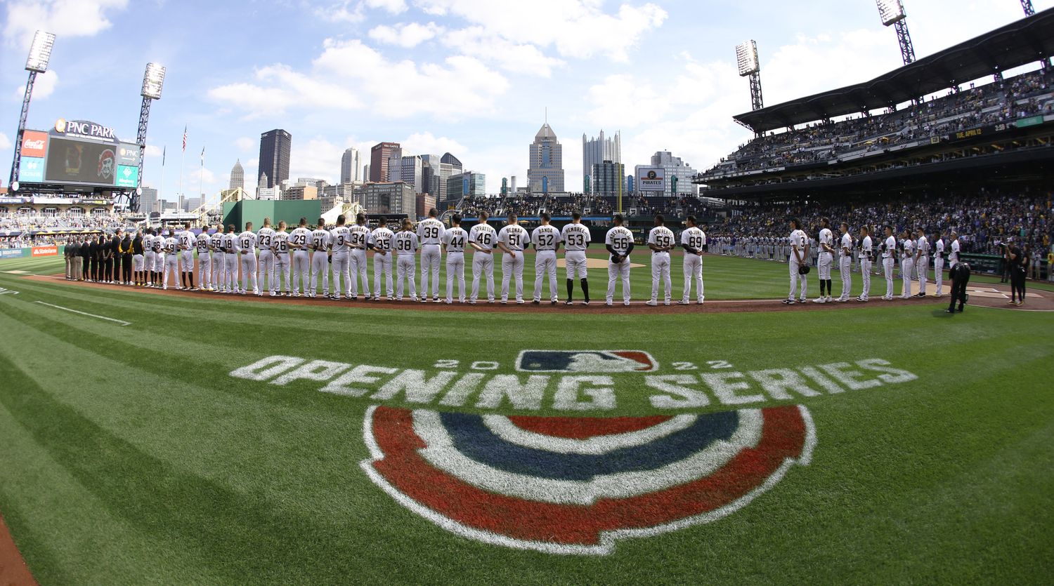 Pittsburgh Pirates players stand in a line for the national anthem before the opening day baseball game