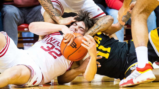 Indiana's Trey Galloway (32) fights with Iowa's Tony Perkins (11) for a loose ball during the first half of the Indiana versus Iowa men's basketball game at Simon Skjodt Assembly Hall.