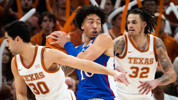 exas Longhorns forward Brock Cunningham (30) forward Christian Bishop (32) defend against Kansas Jayhawks forward Jalen Wilson (10) during the first half of the Longhorns' game against the Jayhawks at the Moody Center in Austin, Saturday, March 4, 2023.