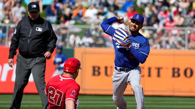 Dodgers second baseman Mookie Betts throws to first base after forcing out Los Angeles Angels’ Mike Trout