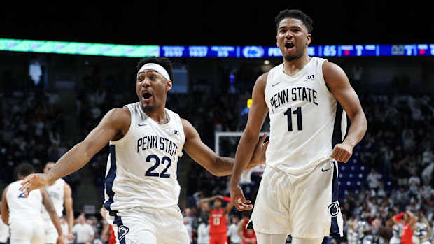 Penn State's Jalen Pickett (22) and Camren Wynter celebrate Wynter's game-winning basket against Maryland in Big Ten Conference basketball.