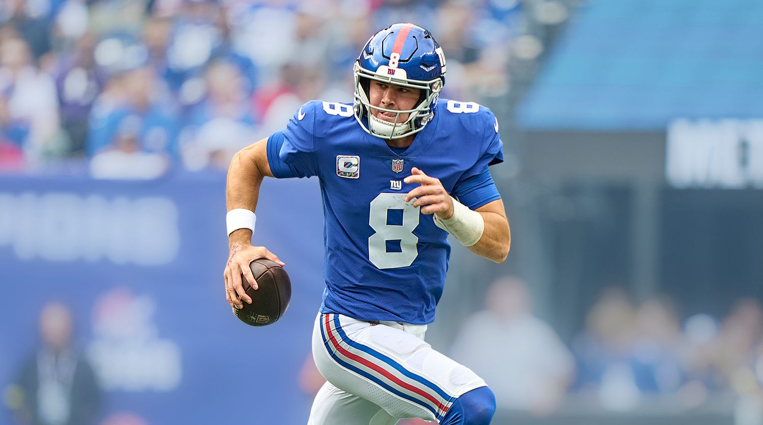 Daniel Jones rolls out of the pocket with the ball