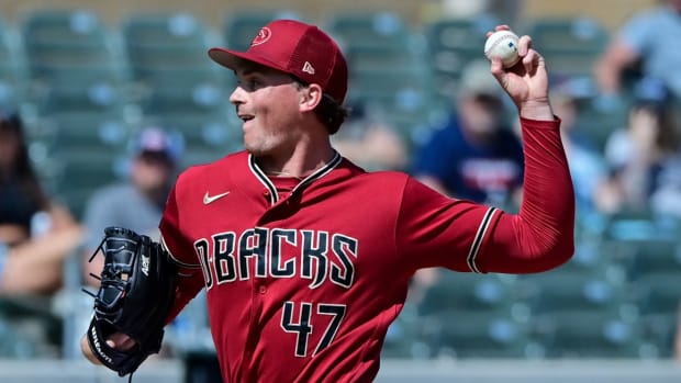 Tommy Henry throws a pitch against the Texas Rangers at Salt River Fields.