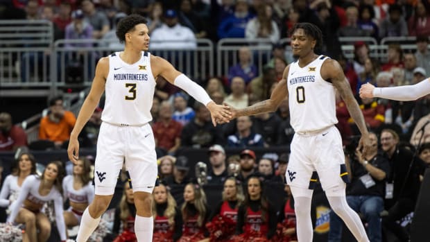 Mar 8, 2023; Kansas City, MO, USA; West Virginia Mountaineers forward Tre Mitchell (3) reacts with guard Kedrian Johnson (0) in the second half against the Texas Tech Red Raiders at T-Mobile Center.