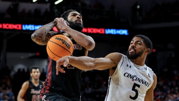 Feb 22, 2023; Cincinnati, Ohio, USA; Temple Owls guard Damian Dunn (1) drives to the basket as he is fouled by Cincinnati Bearcats guard David DeJulius (5) in the second half at Fifth Third Arena. Mandatory Credit: Aaron Doster-USA TODAY Sports