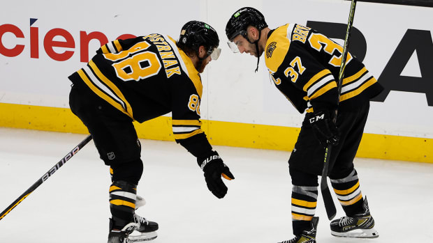 Oct 25, 2022; Boston, Massachusetts, USA; Boston Bruins center Patrice Bergeron (37) congratulates right wing David Pastrnak (88) after their 3-1 win over the Dallas Stars