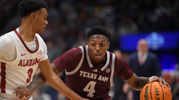Mar 12, 2023; Nashville, TN, USA; Texas A&M Aggies guard Wade Taylor IV (4) dribbles past Alabama Crimson Tide guard Rylan Griffen (3) during the first half at Bridgestone Arena. Mandatory Credit: Steve Roberts-USA TODAY Sports