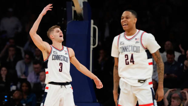 UConn’s Joey Calcaterra and Jordan Hawkins celebrate a three-pointer.