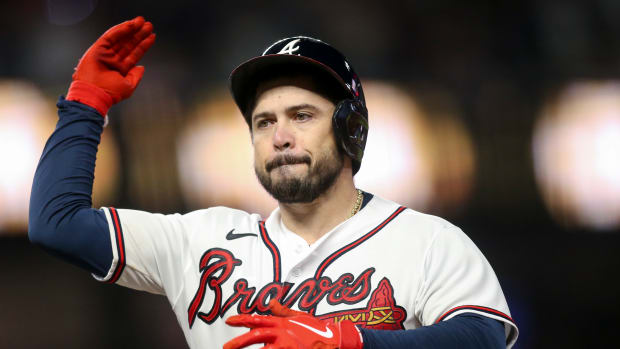 Oct 12, 2022; Atlanta, Georgia, USA; Atlanta Braves catcher Travis d'Arnaud (16) celebrates at first base after hitting an RBI single against the Philadelphia Phillies in the sixth inning during game two of the NLDS for the 2022 MLB Playoffs at Truist Park. Mandatory Credit: Brett Davis-USA TODAY Sports
