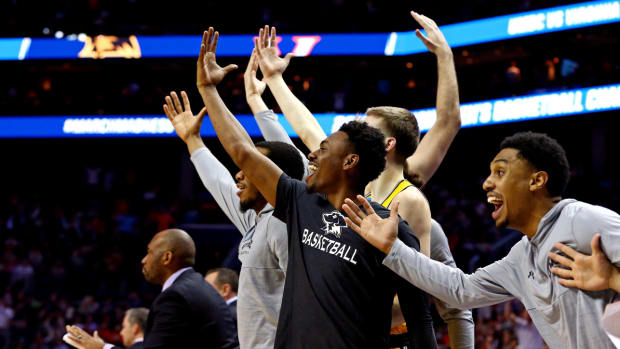 Members of the 2018 UMBC men’s basketball team celebrate during team’s historic win over Virginia.
