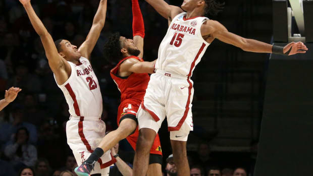 Maryland guard Don Carey (0) gets between Alabama guard Nimari Burnett (25) and Alabama forward Noah Clowney (15) to score at Legacy Arena during the second round of the NCAA Tournament.