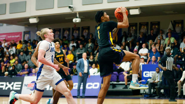 Dec 1, 2022; Montverde, Florida, USA; Montverde guard Chris Johnson (1) is chased by IMG Academy guard Blue Cain in the second quarter during the Sunshine Classic basketball tournament at Mills Championship Court on the campus of Montverde Academy.