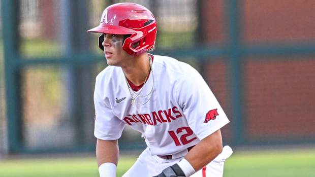 Razorbacks' Tavian Josenberger leads off first base against Alabama on Friday night.