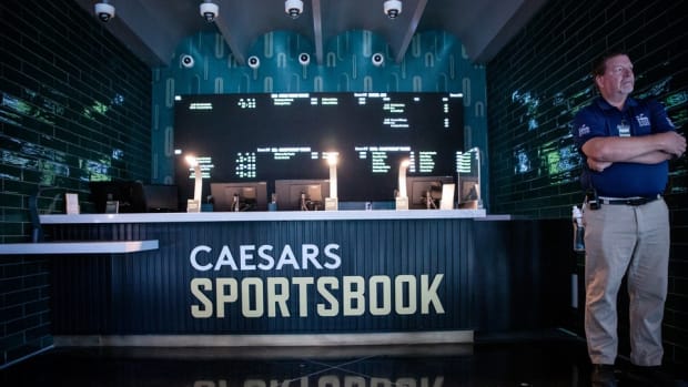 A security guard stands in front of one of the betting windows on the second floor of the Caesars Sportsbook at Chase Field in Phoenix on June 21, 2022.