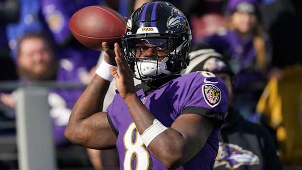 Lamar Jackson throws a ball during pregame warmups