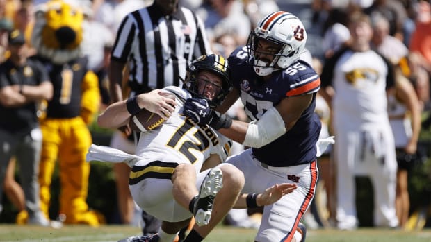 Sep 24, 2022; Auburn, Alabama, USA; Missouri Tigers quarterback Brady Cook (12) is sacked by Auburn Tigers linebacker Eku Leota (55) during the fourth quarter at Jordan-Hare Stadium. Mandatory Credit: John Reed-USA TODAY Sports