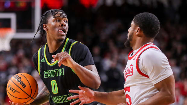 Feb 11, 2023; Cincinnati, Ohio, USA; South Florida Bulls guard Ryan Conwell (0) dribbles against Cincinnati Bearcats guard David DeJulius (5) in the second half at Fifth Third Arena. Mandatory Credit: Katie Stratman-USA TODAY Sports