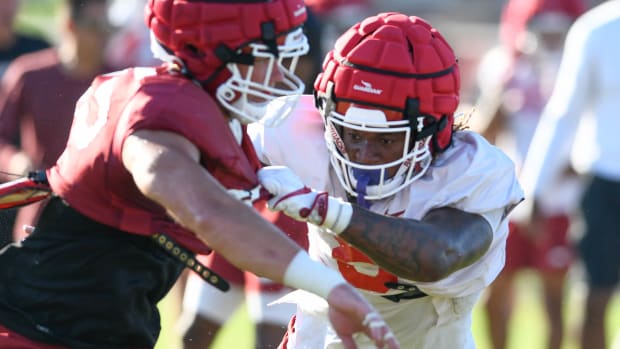 Razorbacks Ty Washington blocking during a preseason scrimmage last year.