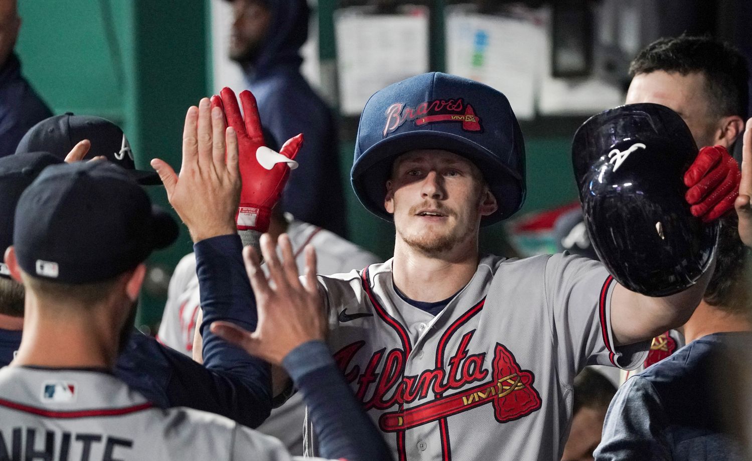 Apr 14, 2023; Kansas City, Missouri, USA; Atlanta Braves catcher Sean Murphy (12) is congratulated in the dugout after hitting a solo home run against the Kansas City Royals in the fifth inning at Kauffman Stadium.
