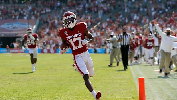 OU's Marvin Mims (17) scores a touchdown during last season's win against Texas in Dallas.