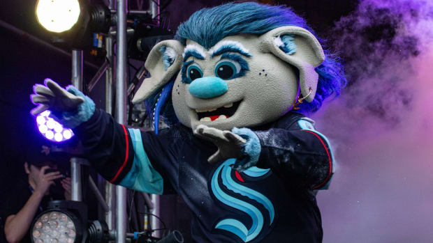Seattle Kraken mascot Buoy exits the tunnel onto the field during an NFL game between the Indianapolis Colts and Minnesota Vikings.