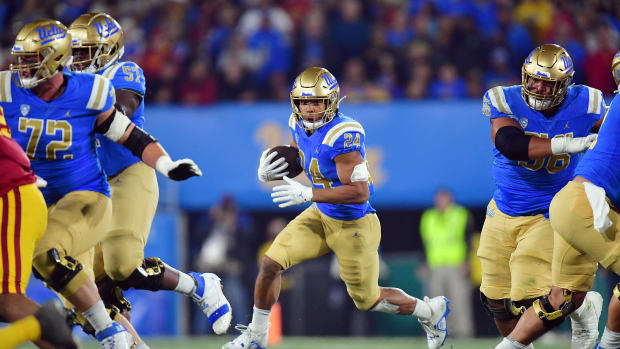 UCLA Bruins running back Zach Charbonnet (24) runs the ball against the Southern California Trojans during the first half at the Rose Bowl.