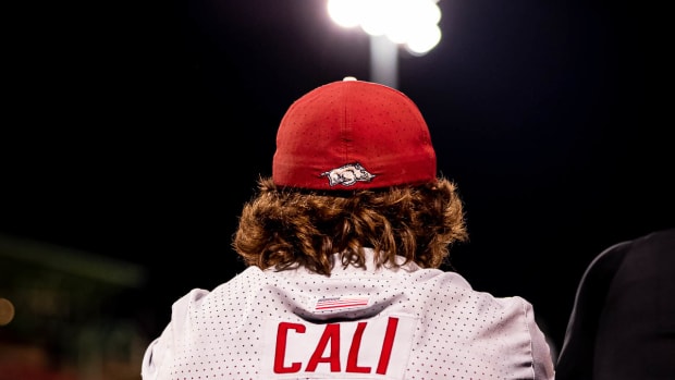 Razorbacks Caleb Cali sits at the top of the dugout steps Tuesday night against Missouri State