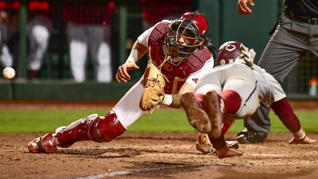 Razorbacks' Parker Rowland makes a tag in the eighth inning to save a run in a 5-5 tie game to set up rally.