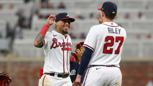 May 9, 2023; Atlanta, Georgia, USA; Atlanta Braves shortstop Orlando Arcia (11) and third baseman Austin Riley (27) celebrate after a victory against the Boston Red Sox at Truist Park.