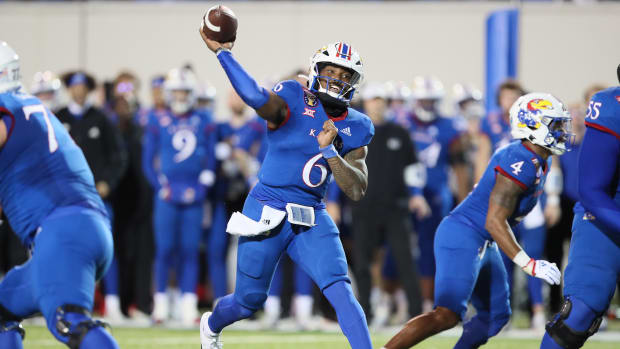 Dec 28, 2022; Memphis, TN, USA; Kansas Jayhawks quarterback Jason Daniels (6) passes in the fourth quarter against the Arkansas Razorbacks in the 2022 Liberty Bowl at Liberty Bowl Memorial Stadium. Arkansas won 55-53. Mandatory Credit: Nelson Chenault-USA TODAY Sports
