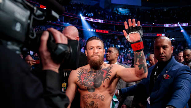 Conor McGregor, shirtless, waves to crowd