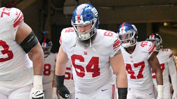Jan 15, 2023; Minneapolis, Minnesota, USA; New York Giants guard Mark Glowinski (64) runs onto the field before a wild card game against the Minnesota Vikings at U.S. Bank Stadium.